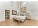 Spacious main bedroom boasts a high ceiling, unique lighting, and stylish decor with hardwood flooring at 3790 Peace River Dr, Punta Gorda, FL 33983