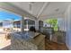 Outdoor kitchen featuring granite countertops, stone accents, built-in grill, and beverage fridge at 3790 Peace River Dr, Punta Gorda, FL 33983
