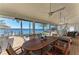 Inviting screened patio with waterfront view, ceiling fan, hammock, and a large wood table with seating for eight at 3790 Peace River Dr, Punta Gorda, FL 33983