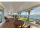 Enclosed patio showcases brick flooring, comfortable seating, and a beautiful waterfront view at 3790 Peace River Dr, Punta Gorda, FL 33983