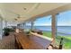 Screened-in patio boasting brick flooring, outdoor dining set, and waterfront views at 3790 Peace River Dr, Punta Gorda, FL 33983