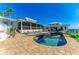 Beautiful backyard pool and spa, surrounded by brick pavers, with lounge chairs and seating areas at 3790 Peace River Dr, Punta Gorda, FL 33983