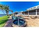 Backyard pool and spa area with brick pavers, green lawn, and views of the waterfront at 3790 Peace River Dr, Punta Gorda, FL 33983