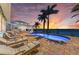 Inviting pool area with comfortable lounge chairs, a backdrop of palm trees, and tranquil waterfront views at sunset at 3790 Peace River Dr, Punta Gorda, FL 33983