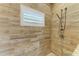 This walk-in shower has stunning tile and a built-in shower seat to add to the ambiance at 3790 Peace River Dr, Punta Gorda, FL 33983
