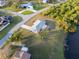 Aerial view of the home showcasing the large, green lawn and water access at 3940 Abbotsford St, North Port, FL 34287