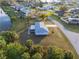 Aerial view of a home with a backyard, canal, and mature landscaping at 3940 Abbotsford St, North Port, FL 34287