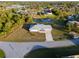 An aerial view showcasing the property with a canal and lush landscaping at 3940 Abbotsford St, North Port, FL 34287