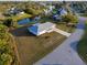 An aerial view of a single-Gathering home with a spacious lawn and a driveway at 3940 Abbotsford St, North Port, FL 34287
