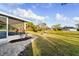 Beautiful backyard featuring manicured lawn, mature trees, and a brick path at 3940 Abbotsford St, North Port, FL 34287