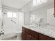 Bathroom featuring tub, shower, marble countertops, ample mirror space, and commode at 3940 Abbotsford St, North Port, FL 34287