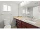 Bathroom featuring a marble countertop, ample mirror space, and under sink storage at 3940 Abbotsford St, North Port, FL 34287