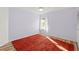 This room features a large red rug, a ceiling fan, and a bright window at 3940 Abbotsford St, North Port, FL 34287