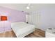 Bedroom features hardwood floors, a large bed and a light purple paint at 3940 Abbotsford St, North Port, FL 34287