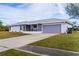 Charming one-story home boasts a well-maintained lawn and a spacious driveway leading to an attached garage at 3940 Abbotsford St, North Port, FL 34287