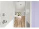 Bright and airy foyer welcomes you with wood laminate flooring, a white front door, and a view into the living space at 3940 Abbotsford St, North Port, FL 34287