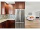 This kitchen features stainless steel appliances, granite countertops, and wood cabinets at 3940 Abbotsford St, North Port, FL 34287