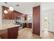 Modern kitchen with stainless steel appliances, granite countertops, and mosaic backsplash at 3940 Abbotsford St, North Port, FL 34287