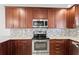 Modern kitchen features stainless steel appliances, granite countertops, and mosaic backsplash at 3940 Abbotsford St, North Port, FL 34287