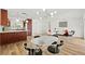 Bright, open-concept living and dining area with wood floors and modern lighting at 3940 Abbotsford St, North Port, FL 34287