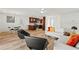 Open-concept living area with wood laminate flooring seamlessly connects the kitchen and dining spaces at 3940 Abbotsford St, North Port, FL 34287