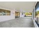 Enclosed patio with screen windows overlooking a well-maintained backyard at 3940 Abbotsford St, North Port, FL 34287