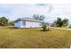 A meticulously kept lawn and a charming display of decorative plants enhance this home's curb appeal at 3940 Abbotsford St, North Port, FL 34287