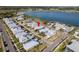 Aerial view of a lakeside community with well-maintained homes, green spaces, and a large lake in the background at 42210 Lake Timber Dr, Punta Gorda, FL 33982