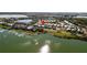 Scenic aerial view showcasing a residential community alongside a lake, surrounded by lush landscaping and natural beauty at 42210 Lake Timber Dr, Punta Gorda, FL 33982