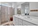 Beautiful bathroom with dual sinks and a glass-enclosed shower at 42210 Lake Timber Dr, Punta Gorda, FL 33982