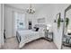 Cozy bedroom with a metal bed frame, neutral decor, and a sunlit window at 42210 Lake Timber Dr, Punta Gorda, FL 33982