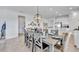 Bright dining room featuring a stylish chandelier and seating for six at 42210 Lake Timber Dr, Punta Gorda, FL 33982