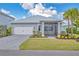 Charming one-story home with well-manicured lawn, screened lanai, paver driveway and attached two-car garage at 42210 Lake Timber Dr, Punta Gorda, FL 33982