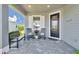 Inviting front porch with rocking chairs and a bench, perfect for enjoying the outdoors at 42210 Lake Timber Dr, Punta Gorda, FL 33982