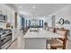 Spacious open kitchen with modern appliances, a large island, and views of the living area at 42210 Lake Timber Dr, Punta Gorda, FL 33982