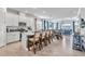 Open-concept kitchen with white cabinets, a large island with seating, and stylish pendant lighting at 42210 Lake Timber Dr, Punta Gorda, FL 33982