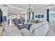 Open concept living room with large windows and access to dining and kitchen at 42210 Lake Timber Dr, Punta Gorda, FL 33982