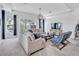 Spacious living room with ample seating, large windows, and contemporary decor at 42210 Lake Timber Dr, Punta Gorda, FL 33982