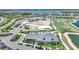 Scenic aerial view of a golf course community featuring a clubhouse, and a pool under construction, and manicured grounds at 42239 Lake Timber Dr, Punta Gorda, FL 33982