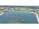Aerial of the new neighborhood overlooking a beautiful lake with an adjacent golf course at 42239 Lake Timber Dr, Punta Gorda, FL 33982