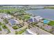 Aerial view of new neighborhood featuring colorful community buildings, pool, and a picturesque lake at 42239 Lake Timber Dr, Punta Gorda, FL 33982