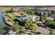 Aerial view of community's lakefront dining and commercial area with lush tropical landscaping at 42239 Lake Timber Dr, Punta Gorda, FL 33982