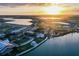 High aerial view of new neighborhood with parks, commercial centers, and lake at sunset at 42239 Lake Timber Dr, Punta Gorda, FL 33982