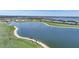 Aerial view of the community by the lake, showcasing the golf course and waterfront homes at 42239 Lake Timber Dr, Punta Gorda, FL 33982
