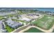 Community aerial of a new construction neighborhood with golf course, pools, and tennis courts at 42239 Lake Timber Dr, Punta Gorda, FL 33982