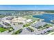 Aerial view of the community showcasing homes, a golf course, and lakes in a sunny locale at 42239 Lake Timber Dr, Punta Gorda, FL 33982