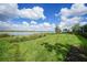 Lush backyard with well-maintained lawn and serene lake view, offering a tranquil outdoor space at 42239 Lake Timber Dr, Punta Gorda, FL 33982