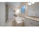 Bathroom showcasing an enclosed glass shower, soaking tub and white vanity with granite countertop at 42239 Lake Timber Dr, Punta Gorda, FL 33982