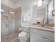 Contemporary bathroom featuring a glass shower and white vanity with granite countertop at 42239 Lake Timber Dr, Punta Gorda, FL 33982