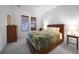 Cozy bedroom with tufted leather headboard, side tables, and carpeted floors at 42239 Lake Timber Dr, Punta Gorda, FL 33982